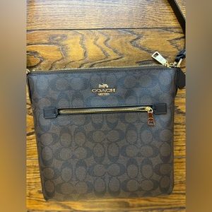 Coach brand brown coloured crossbody bag.